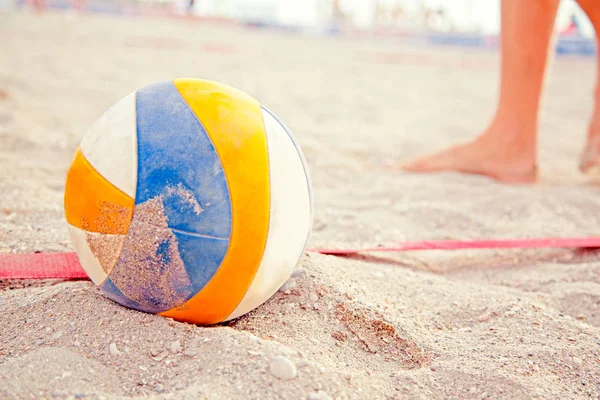 Beach Volleyball. Game ball under sunlight and blue sky. Volleyball in the sand at the beach — Stock Photo, Image