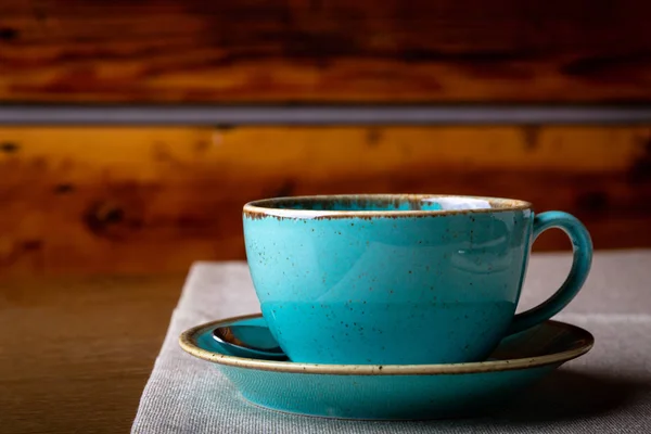 Beautiful Delicious Latte art, Blue coffee cup on wooden background.