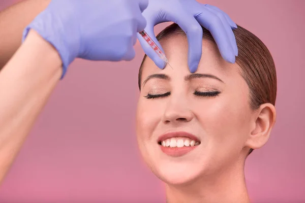 Beautiful woman face and beautician hands with syringe. Doctor makes cosmetic injection in the upper lip. Clean Beauty concept — Stock Photo, Image