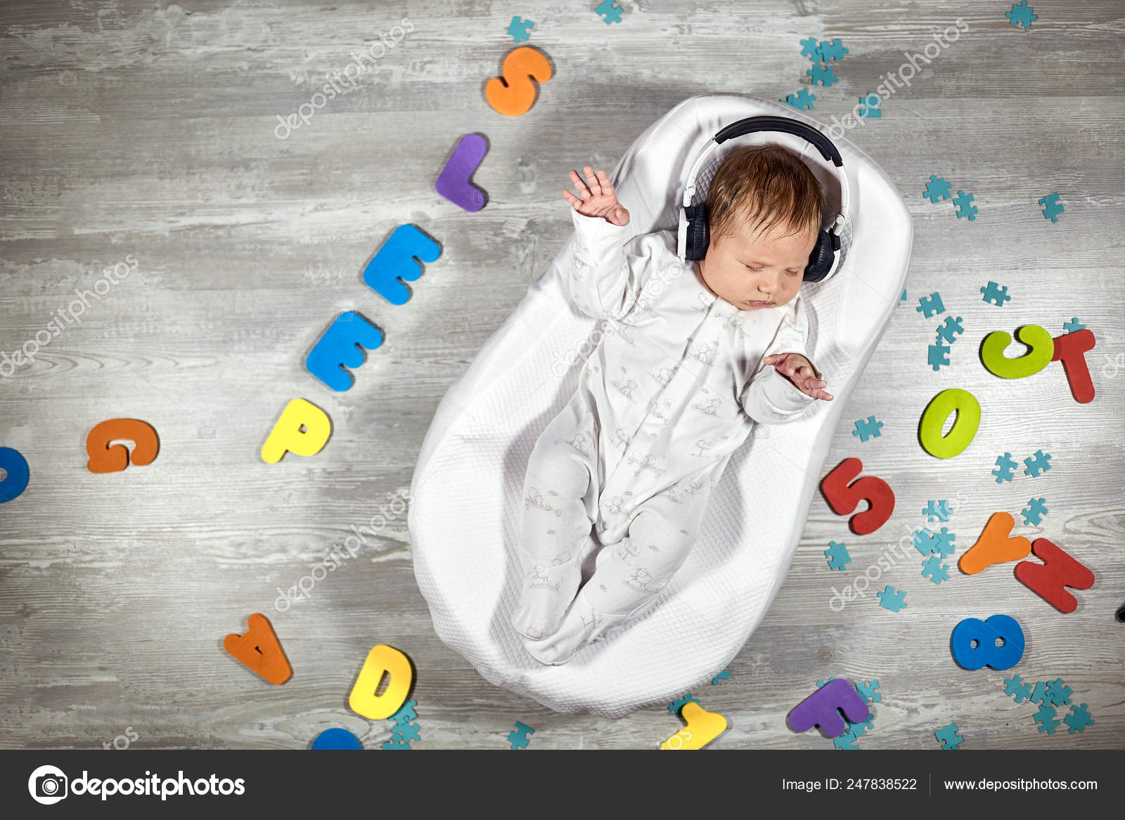Newborn Baby In Headphones Sleeps In A Special Mattress Baby