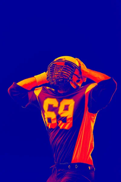 Isolated American football player rejoices in victory. Special effect neon light. — Stock Photo, Image