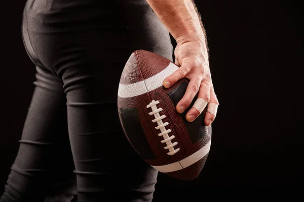 American Football-Spieler hält Ball gegen düsteren Himmel — Stockfoto