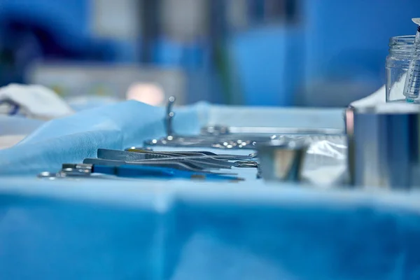 selective focus surgical instrument lying on table, emergency case, surgery, medical technology, health care cancer, disease treatment concept