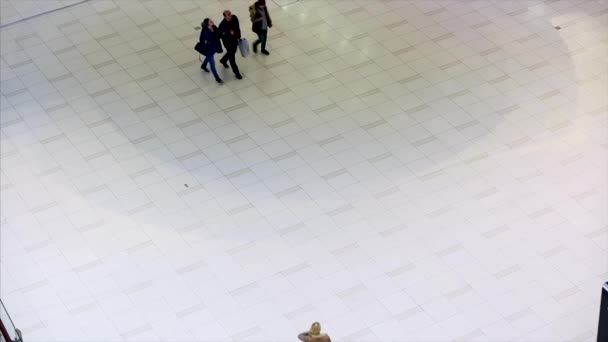 Top view of walking people in large hall of modern building interior in shopping mall. — Stock Video