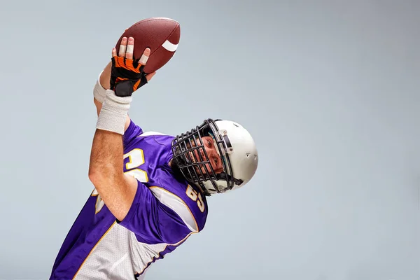 American football sportsman player on black background. Sport concept.