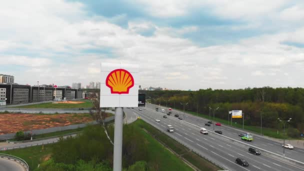 Moscow, Russia - May 06, 2019: Aerial shooting Shell Oil Logo on a sign next to a gas station. A shot from a quadrocopter around the Shell Oil logo in the city near the highway. — Stock Video