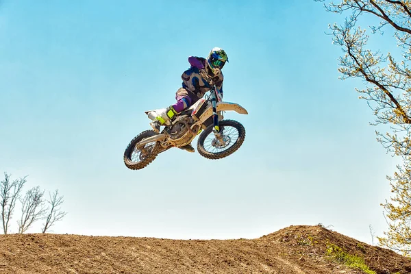 Olahraga ekstrim, lompat sepeda motor. Pengendara sepeda motor membuat lompatan ekstrem melawan langit . — Stok Foto