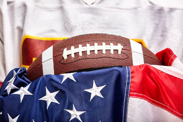 American football concept, ball on american flag background and american football uniform.