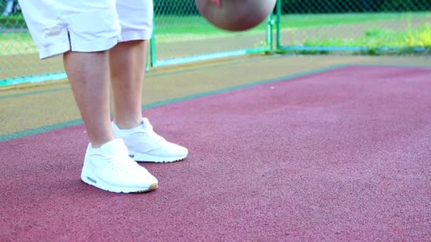 Basketbal op straat, trainen voor het jongleren van een bal voor basketbal. Het concept van sport, training, training op straat, Zelfmotivatie, discipline, succes behalen. Close-up. — Stockvideo