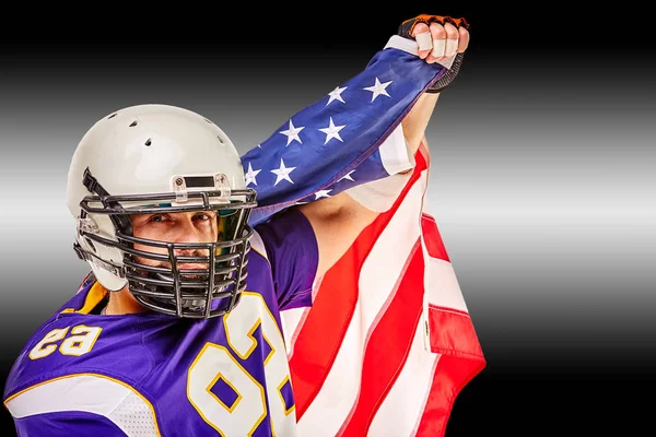 American football player closeup portrait. American football player with an american flag in his hands. Concept patriotism, celebration.