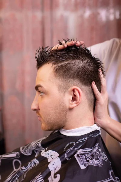 Крупный план студента мужского пола, стригущего волосы стрижкой — стоковое фото