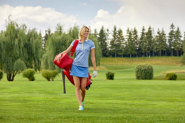 Golf course, a beautiful girl getting ready to hit the ball. Lifestyle concept, golf concept, pursuit of excellence, craftsmanship, royal sport, sports banner.