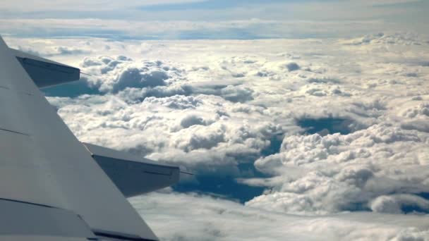 Beautiful cloud and wing of airplane from window with a nice blue sky — Stock Video