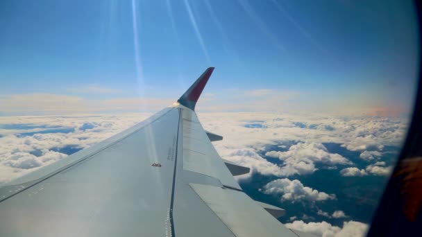 Beautiful cloud and wing of airplane from window with a nice blue sky — Stock Video