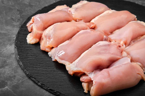 Boneless chicken thigh fillet ready to cook. Organic products, layout for a healthy diet and organic restaurant cooking advertisement