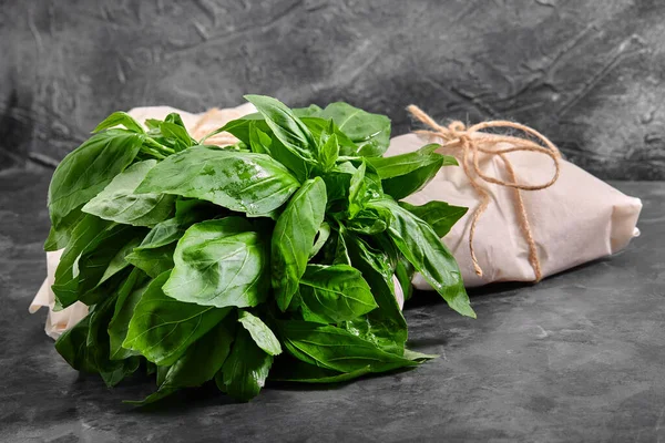 Fresh basil on a dark background. Green basil. Green basil on a dark background. Food background.