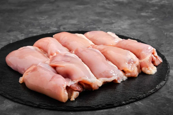 Boneless chicken thigh fillet ready to cook. Organic products, layout for a healthy diet and organic restaurant cooking advertisement