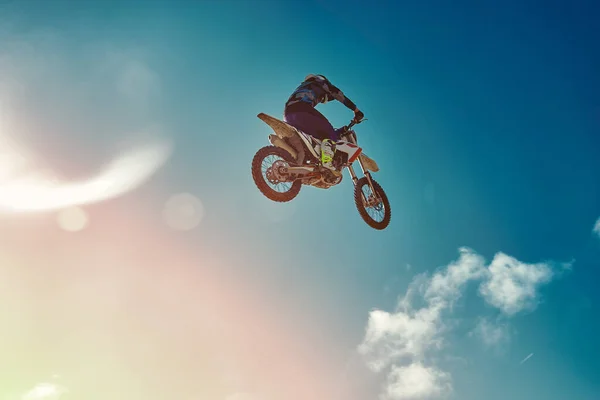 Concepto extremo, desafíate. Salto extremo en una motocicleta sobre un fondo de cielo azul con nubes. Copiar espacio, todo o nada . —  Fotos de Stock