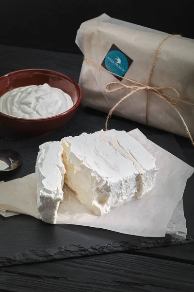 homemade cheese, milk and cottage cheese on a wooden background. rustic style. Set of dairy products, assortment of milk, cottage cheese, sour cream and yogurt