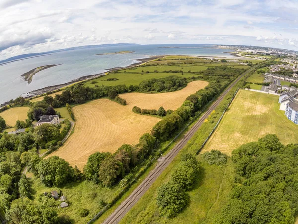 Train rail, fields and buildings in Galway bay — Stock Photo, Image