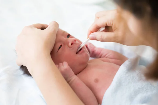 Asian Newborn Baby Cleaning Tongue Cheek Bulge Mouth Bath Stock Image
