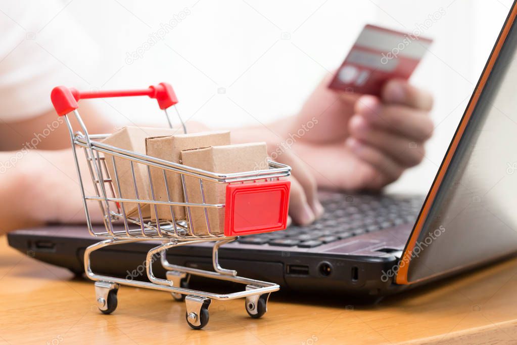 Hand men using laptop and buy goods from a seller over the internet. online shopping concept