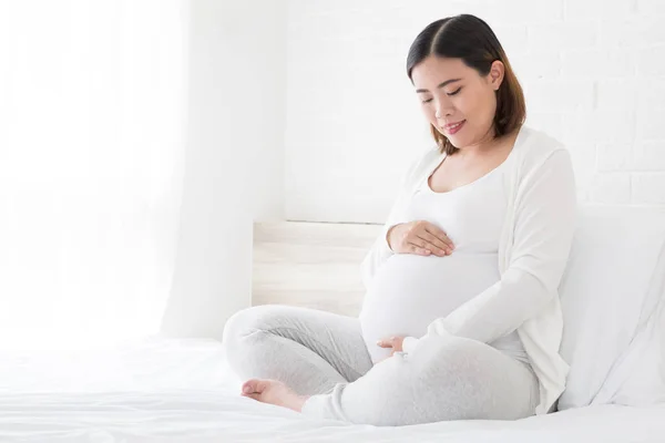 Happy Asian Pregnant Woman Sitting Bed Touching Her Belly Home — Stock Photo, Image