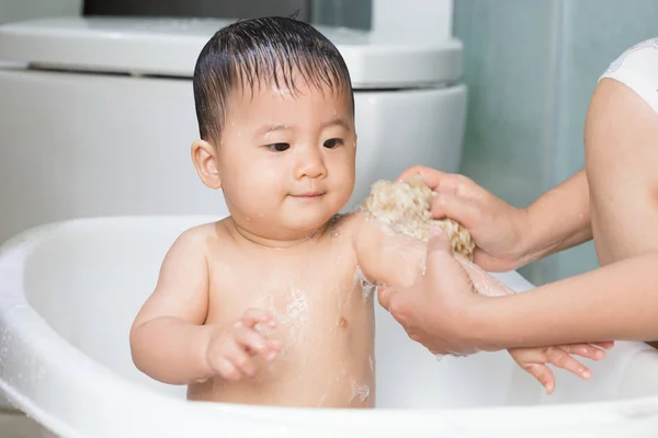Asian baby boy take a bath in bathtub