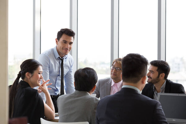 Chief businessman standing at conference table during team meeting, Entrepreneurs making deal starting collaboration at group negotiations teamwork