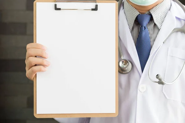 Close-up of a male doctor with lab coat and holding blank clipboard