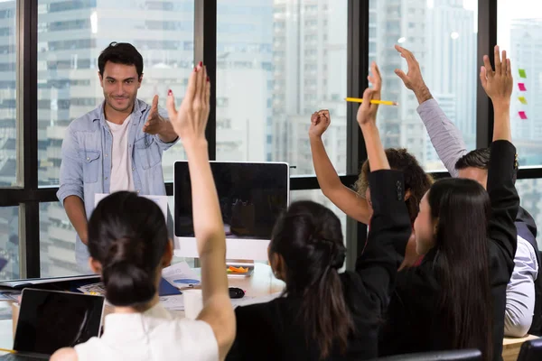 Business people raising there hand up at a conference meeting to answer a question, Opportunity to comment concept