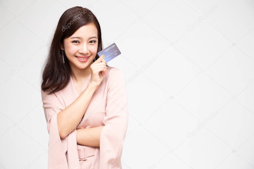 Happy Asian woman holding credit card or cash advances, Pay instead of money and specially curated benefits for lady card concept