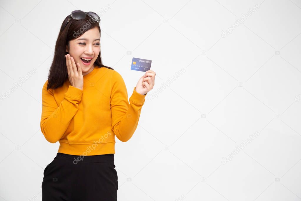 Happy Asian woman holding credit card or cash advances, Pay instead of money and specially curated benefits for lady card concept