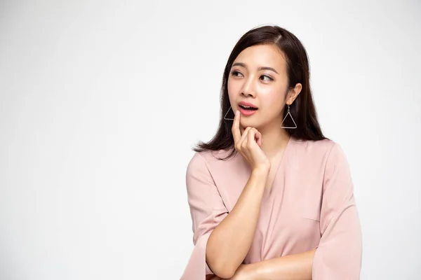 Young Asian lady thinking and looking aside isolated over white background — Stock Photo, Image