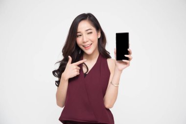 Portrait of beautiful Asian wowan showing or presenting mobile phone application on hand isolated over white background clipart