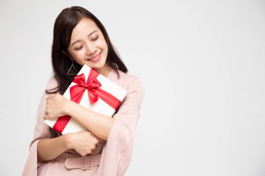 Happy beautiful asian woman smile and hugging gift box isolated on white background. Teenage girls in love, Receiving gifts from lovers. New Year, Christmas and Valentines Day concept clipart