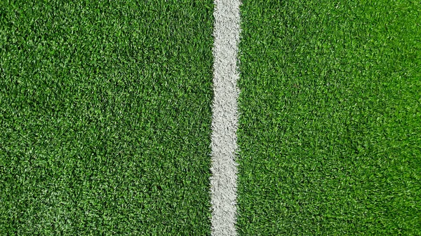 White stripe on the green soccer field from top view