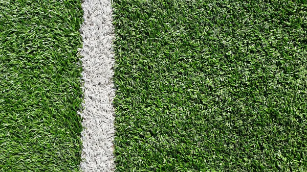 White stripe on the green soccer field from top view