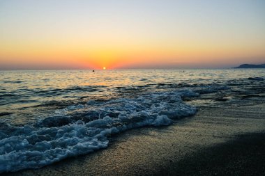 Gün batımında sahilde dalgalar