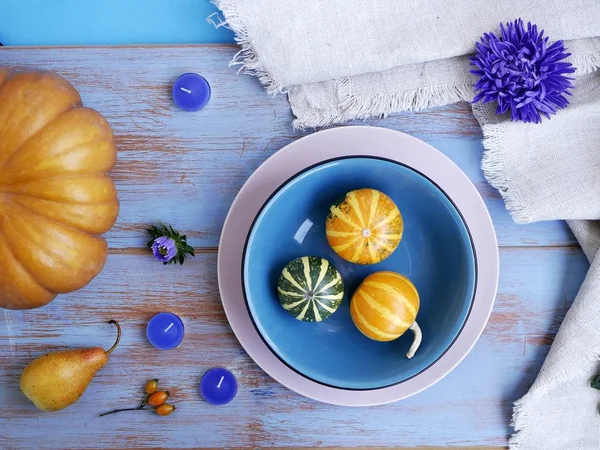 Kabakları çiçekler, mumlar hafif ahşap arka plan, üstten görünüm üzerinde dekoratif sonbahar bileşimi. Tatil, Cadılar Bayramı, sonbahar sezon