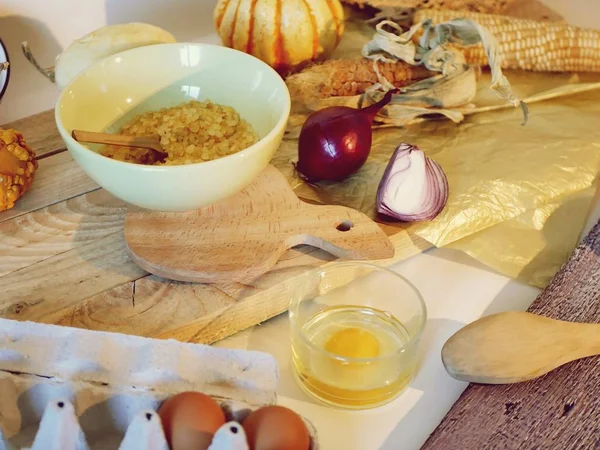 Eggs, pumpkins, sea salt on a light table, top view, home cooking ingredients, shades of yellow