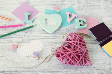 Anneler günü tatili, toplu harflerden aşk kelimesinin kompozisyonu, dekor, kağıt, masadaki kalemler, üst görünüm