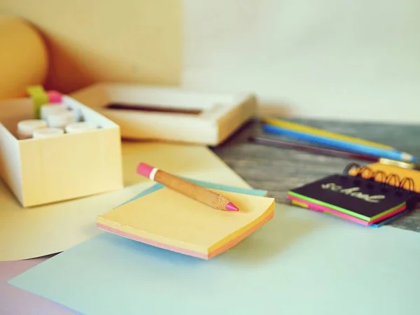 Notebook, art and stationery materials, a frame on a wooden table, back to school, preparation for learning, education