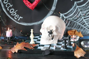 Cadılar Bayramı için iç dekorasyon için dekoratif kompozisyon, kafatası, yanan mumlar, dekor, sonbahar yaprakları, yazıt 31 Ekim ile siyah bir arka plan üzerinde aydınlatma