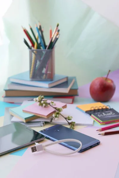 School stationery, tablet, phone on the desk, home schooling concept, part interior children\'s room, back to school