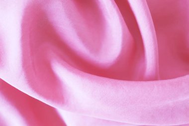 Texture of pink natural silk, folds, top view, background for romantic congratulations, emotion of love