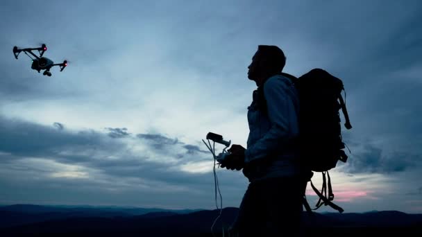 Hiker controlling quadcopter using smartphone — Stock Video