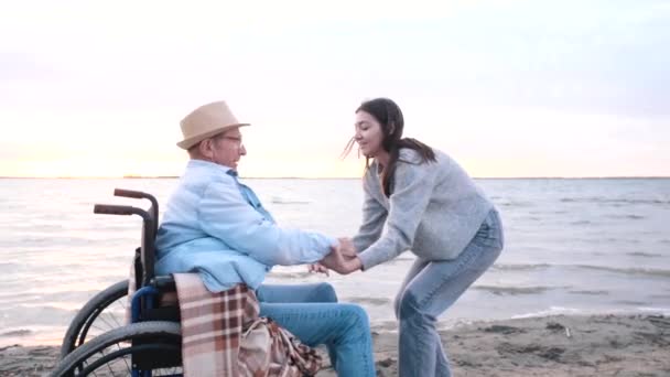 Happy granddaughter raises old disabled grandfather, wheelchair rehabilitation — Stock Video