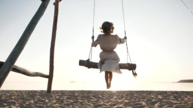 Mutlu kız özgürlüğün tadını çıkar, salıncakta sallan, deniz rahatla güzel cennette dinlen