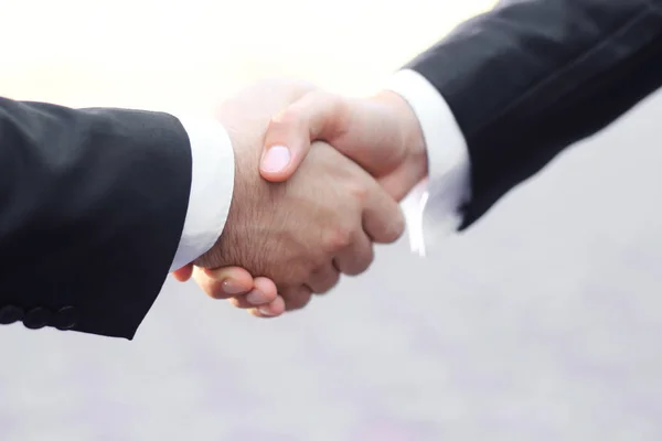 close up.business handshake .isolated on white background.